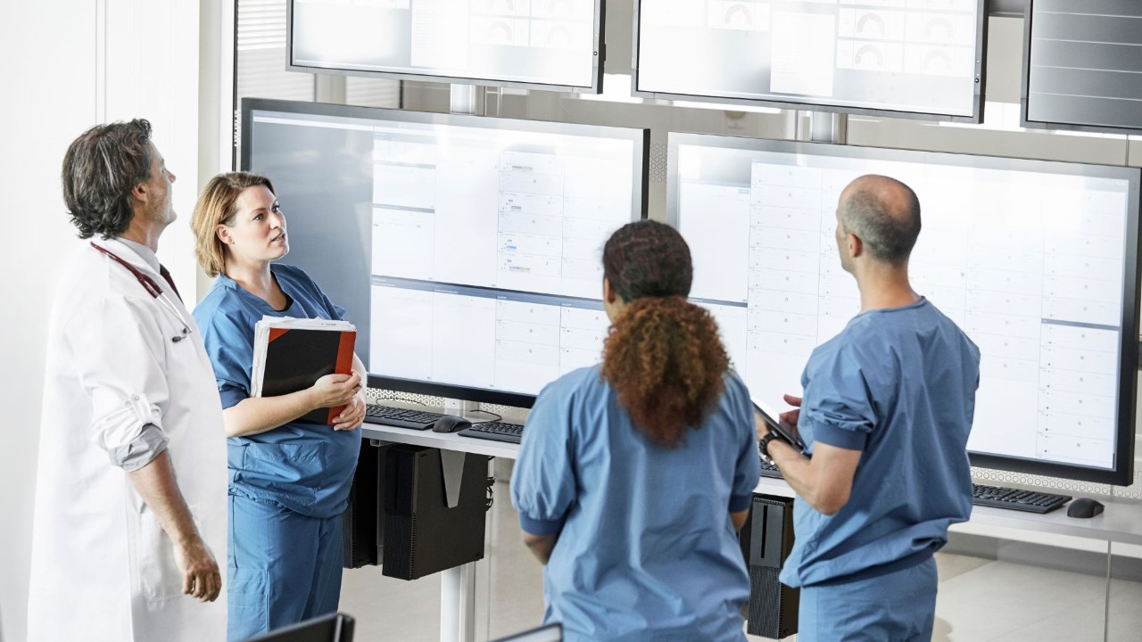 Doctors meeting around whiteboard