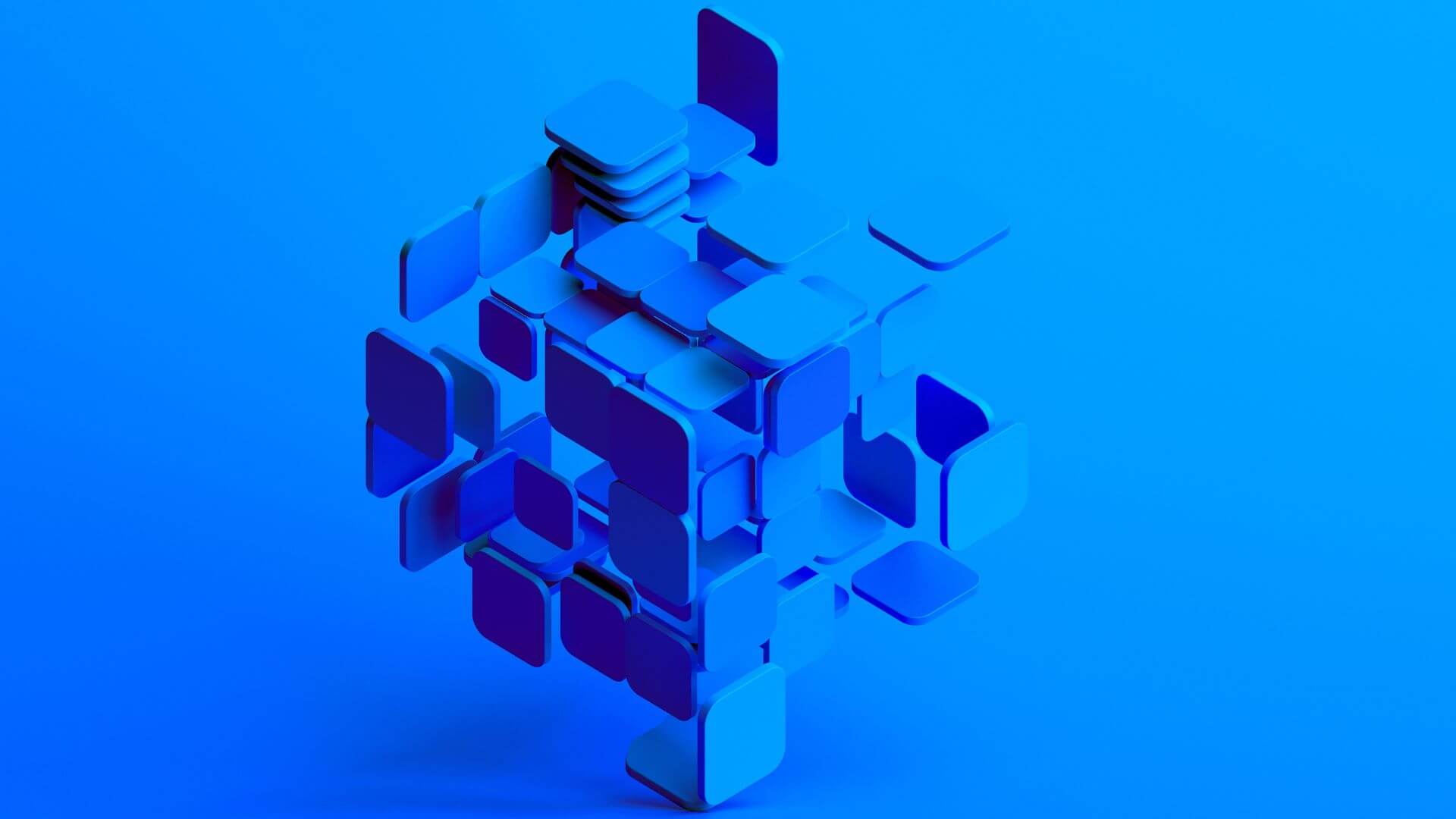 blue 3d tiles joining together to form a cube