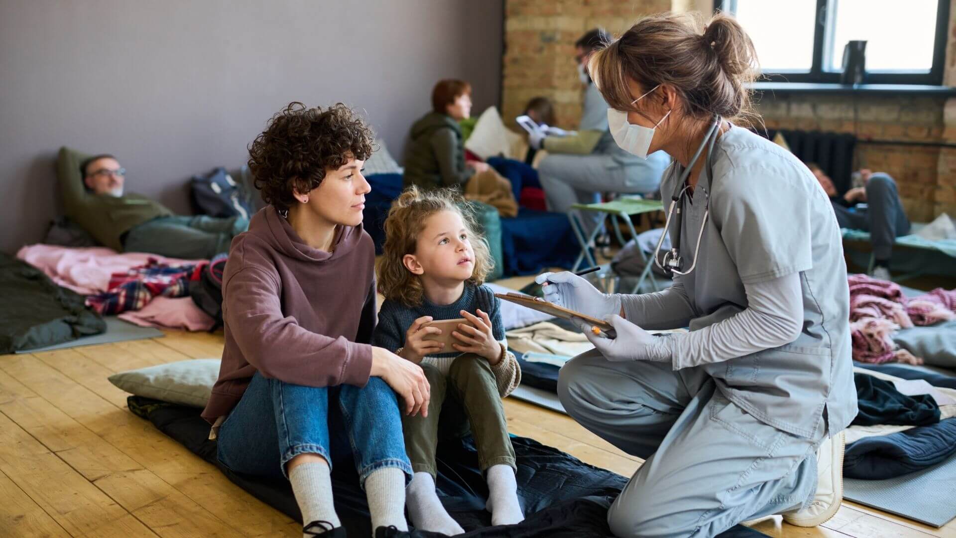 doctor speaking with migrant family