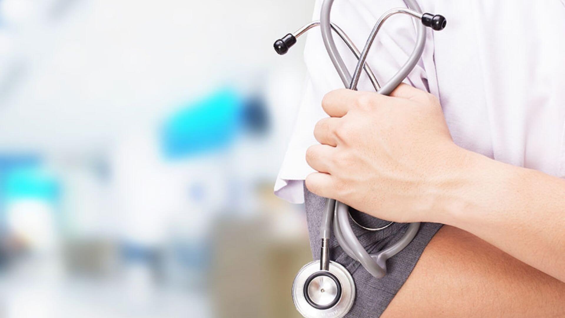 closeup of doctor's hand holding a stethoscope