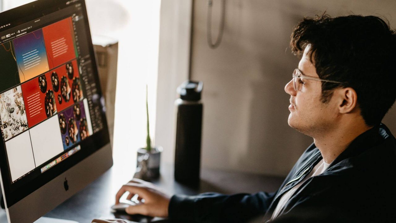 A graphic designer working at a mac computer