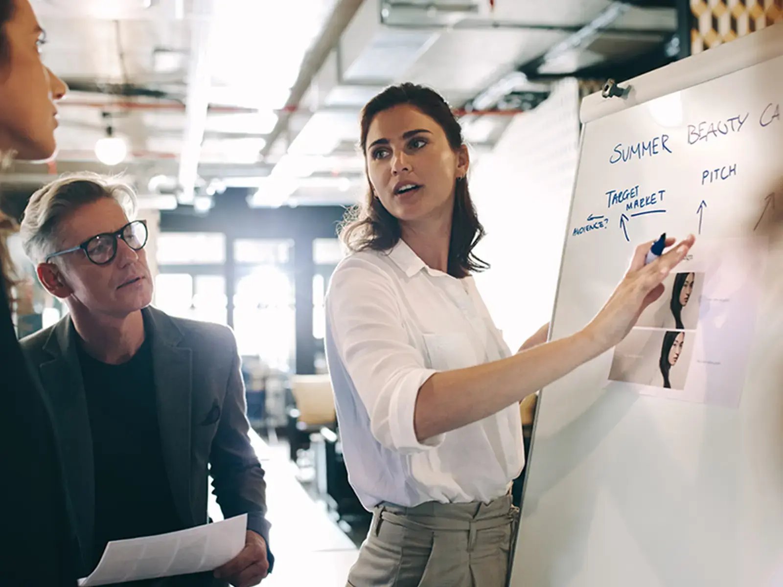 Person presenting marketing campaign to colleagues