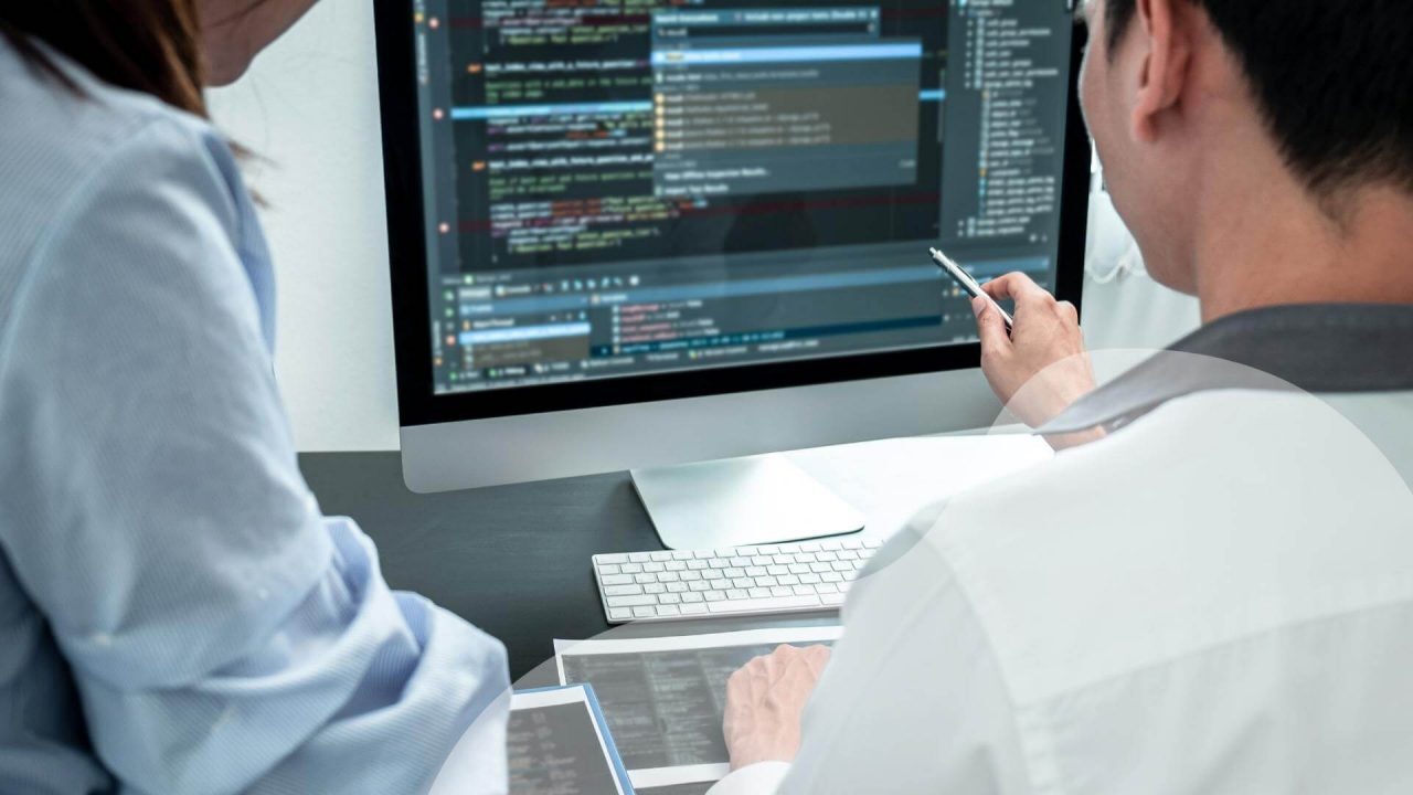 coworkers validating data on screen