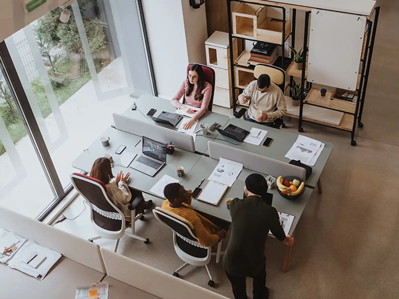 aerial view of office workers at their desks near window