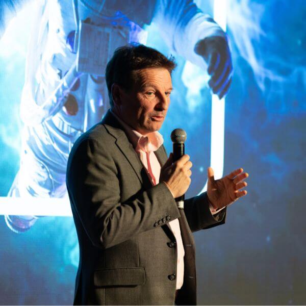 Bertrand Gstalder, Acolad CEO, on stage during event with live interpreting