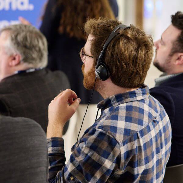 man at event listening to live interpretation through headset
