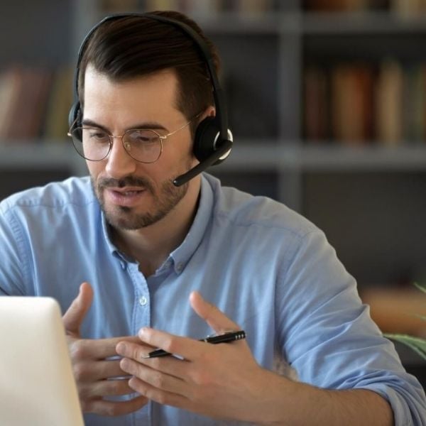 businessman in office wearing headset on a digital call