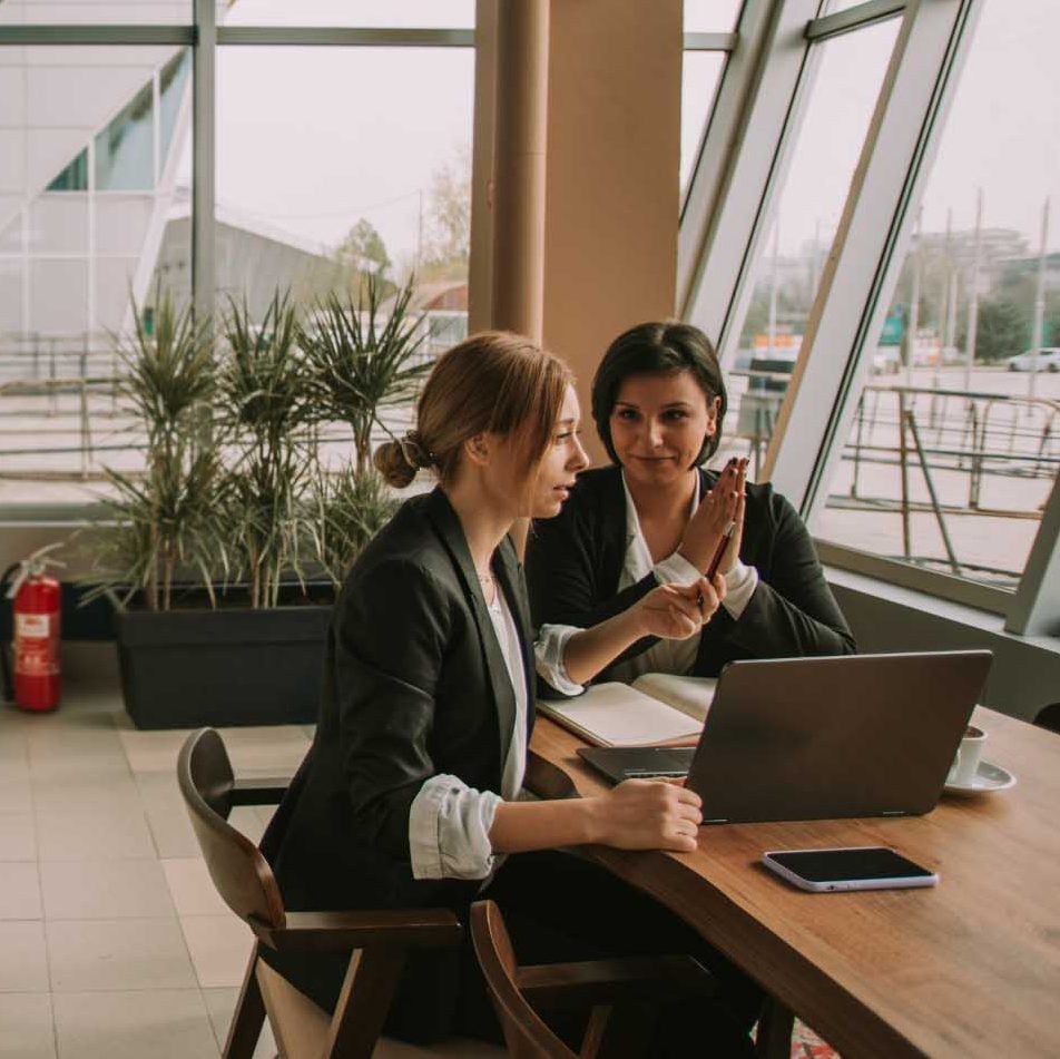 two people in a meeting at a table