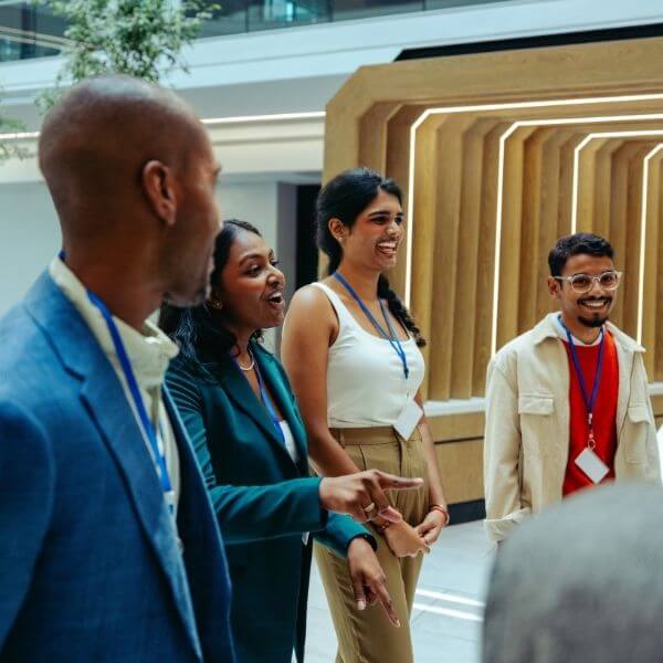 diverse team standing and chatting in communal office area