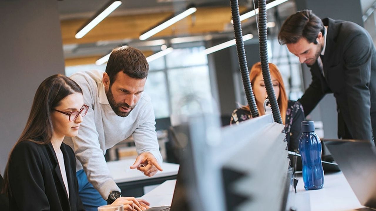 Group of four people working together in an office