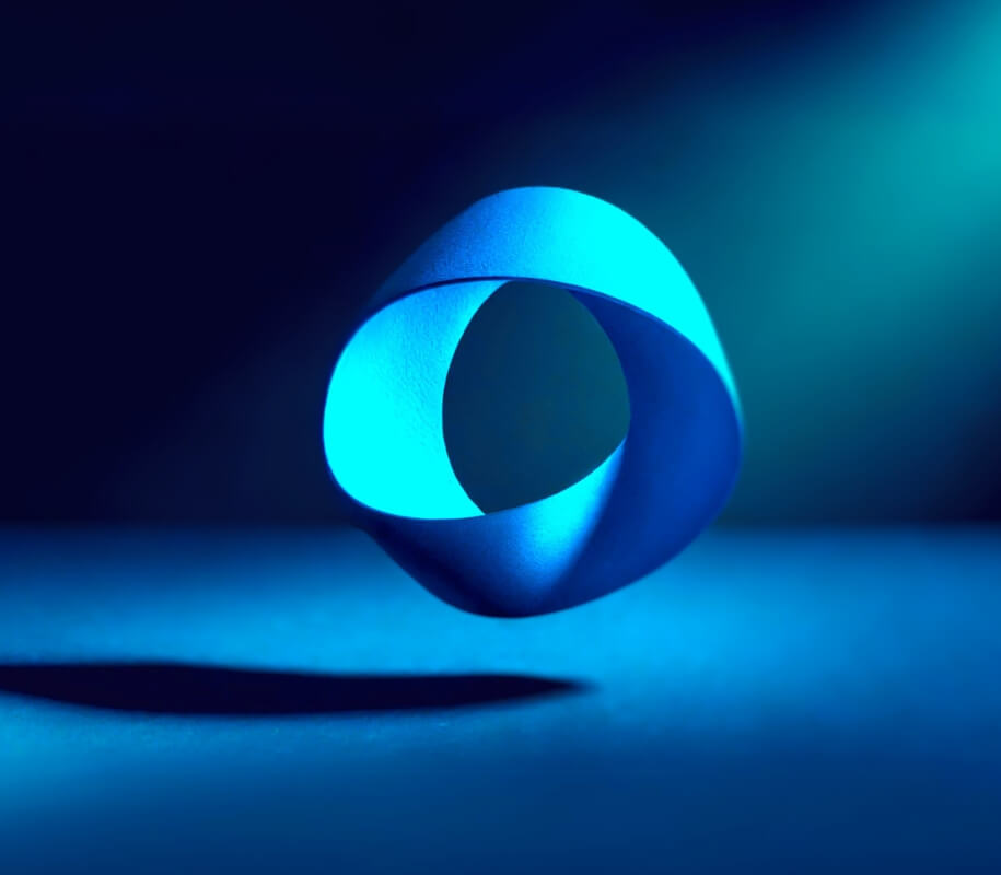 3d rendered blue mobius strip against dark background