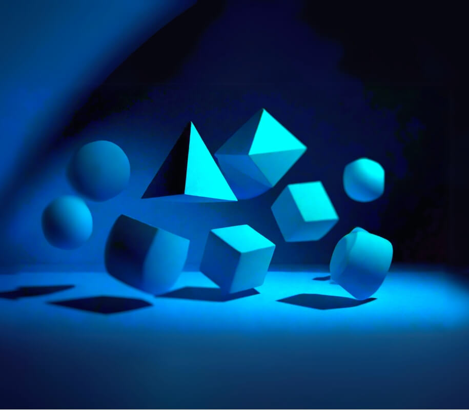 3d rendered blue shapes scattered against dark background