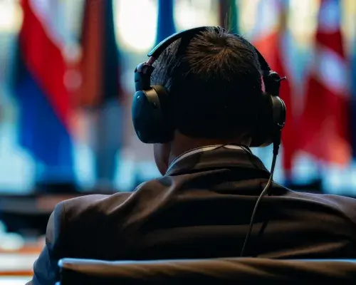 man listening to interpreting translation during meeting