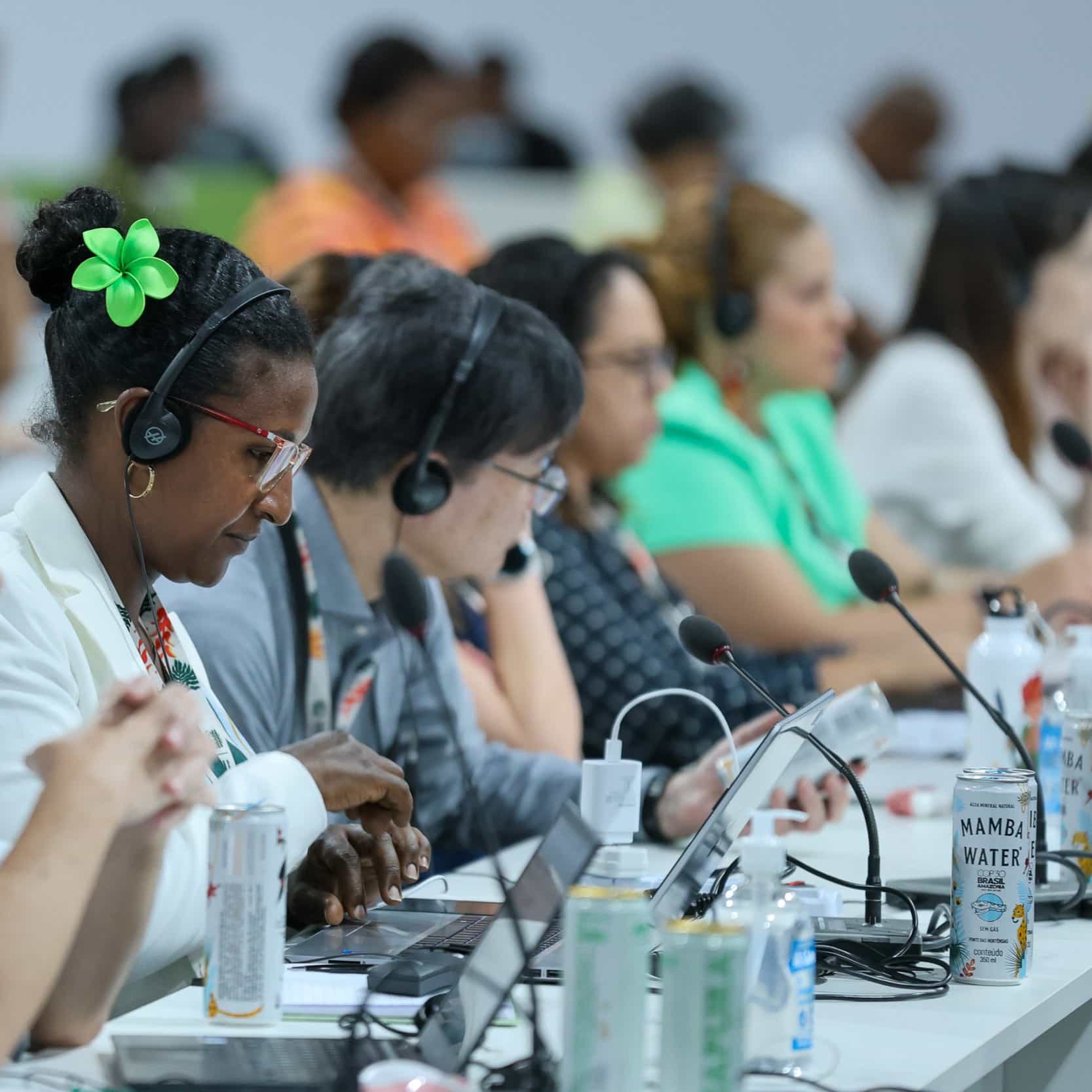 people using interpreting headsets at COP30 - Photo by IISD/ENB | Mike Muzurakis