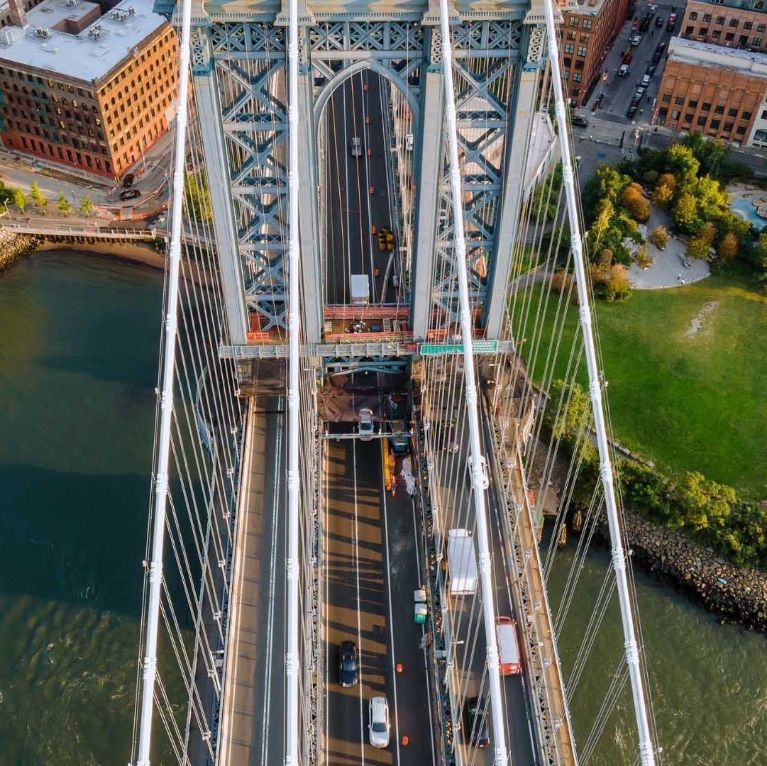 aerial view looking down at cars passing a bridge in New York aerial view looking down at cars passing a bridge in New York