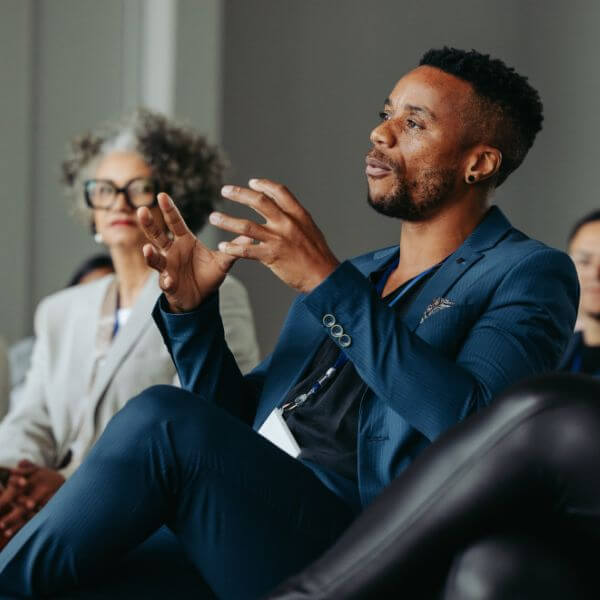 man speaking at event panel