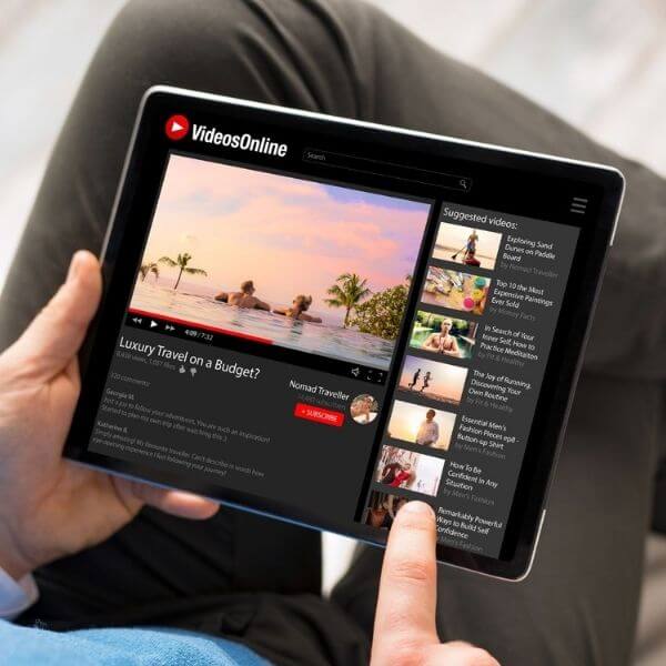 person using tablet scrolling through video playlist person using tablet scrolling through video playlist