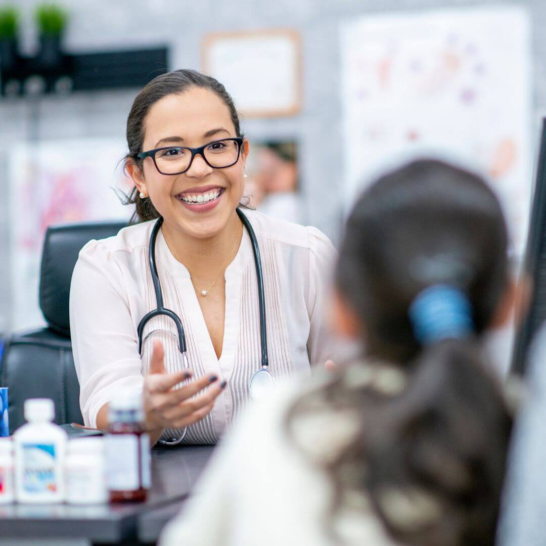 female doctor with glasses smiling during meeting female doctor with glasses smiling during meeting